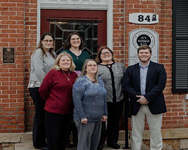 Ott, Norman & Co., CPAs staff in a group photo in front of the office building.